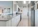 Well-lit kitchen with stainless steel appliances and white cabinets at 7505 Wexford St, North Port, FL 34287