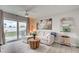 Cozy living room with a comfortable sofa, ceiling fan, and a sliding glass door leading to the backyard at 7505 Wexford St, North Port, FL 34287