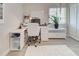 Bright office space with a modern desk, a white rug, and natural light from the window at 7505 Wexford St, North Port, FL 34287