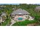 Aerial view of a luxurious home showcasing its sparkling pool and lush surroundings at 755 Eagle Point Dr, Venice, FL 34285