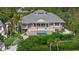 Aerial view of the home showcasing a swimming pool, balconies, lush greenery and architecture at 755 Eagle Point Dr, Venice, FL 34285