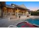 A covered patio, outdoor swimming pool, and hot tub enhance this beautiful home's outdoor space at 755 Eagle Point Dr, Venice, FL 34285