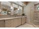 Elegant bathroom with double sinks, vanity, and shower with neutral color palette at 755 Eagle Point Dr, Venice, FL 34285
