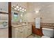 Charming bathroom with a unique vanity, sink, and floral wallpaper at 755 Eagle Point Dr, Venice, FL 34285