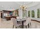 Dining room with chandelier with view of the kitchen and waterway at 755 Eagle Point Dr, Venice, FL 34285