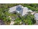 Aerial view of a beautiful, well-kept home with a circular driveway and plenty of mature landscaping at 755 Eagle Point Dr, Venice, FL 34285