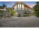 View of the home featuring a beautiful exterior, ample lighting, and tropical landscaping at dusk at 755 Eagle Point Dr, Venice, FL 34285