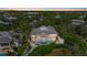 Stunning waterfront home featuring an outdoor pool and lush tropical landscaping and an outdoor kitchen at 755 Eagle Point Dr, Venice, FL 34285