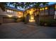 Elegant home with a two-car garage, inviting stairway, and warm exterior lighting at 755 Eagle Point Dr, Venice, FL 34285