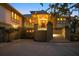 Twilight view of home featuring an attached two-car garage, grand entrance stairs with manicured landscaping at 755 Eagle Point Dr, Venice, FL 34285