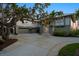 Twilight view of home featuring an attached three-car garage, grand entrance stairs, and manicured landscaping at 755 Eagle Point Dr, Venice, FL 34285