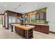 Gourmet kitchen island with cooktop and bar seating with a waterway view at 755 Eagle Point Dr, Venice, FL 34285
