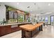 Gourmet kitchen island with cooktop and bar seating with a waterway view at 755 Eagle Point Dr, Venice, FL 34285