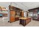 Gourmet kitchen featuring custom wood cabinetry and a large center island at 755 Eagle Point Dr, Venice, FL 34285