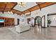 Spacious living room with high ceilings, wood beams, tile floors, and large windows at 755 Eagle Point Dr, Venice, FL 34285