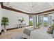 Relaxing bedroom with a private balcony offering scenic waterfront views at 755 Eagle Point Dr, Venice, FL 34285