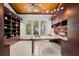 Home office with built-in shelves, custom desk, and views of the water at 755 Eagle Point Dr, Venice, FL 34285