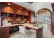 Comfortable home office with desk, cabinets, and decorative lighting at 755 Eagle Point Dr, Venice, FL 34285