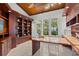 Home office with built-in shelves, large windows, and a custom desk at 755 Eagle Point Dr, Venice, FL 34285