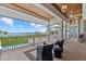 Scenic patio with water views, comfortable seating, and a cooling ceiling fan at 755 Eagle Point Dr, Venice, FL 34285