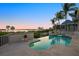 Stunning infinity pool offers panoramic waterfront views, set against a backdrop of lush palm trees at 755 Eagle Point Dr, Venice, FL 34285