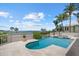 A luxury pool with water views surrounded by lush landscaping, perfect for relaxation at 755 Eagle Point Dr, Venice, FL 34285