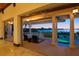 Spacious outdoor porch featuring comfortable seating and stunning water views at sunset at 755 Eagle Point Dr, Venice, FL 34285