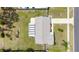 Birds eye view of home and surrounding yard with a long driveway and mature shade trees at 7582 Lyncrest St, North Port, FL 34287