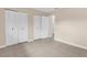 Bedroom with tile floor, closet with louvered doors, adjacent to a bathroom and ready for new decor at 7582 Lyncrest St, North Port, FL 34287