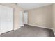 Bedroom showcasing closet with louvered doors, light beige walls, and wood-look tile floor at 7582 Lyncrest St, North Port, FL 34287