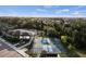 Aerial shot of community amenities including a pool, clubhouse, and tennis courts, surrounded by lush trees at 7582 Lyncrest St, North Port, FL 34287
