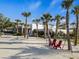 Inviting outdoor area with hammocks, adirondack chairs, palm trees and manicured landscape, promoting relaxation at 7582 Lyncrest St, North Port, FL 34287