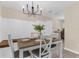 Elegant dining area with a modern chandelier, comfortable seating, and built-in storage cabinets, perfect for entertaining guests at 7582 Lyncrest St, North Port, FL 34287