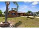 Charming single story home with manicured lawn and stone column accents by the front door and driveway at 7582 Lyncrest St, North Port, FL 34287
