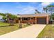 Charming single-story home featuring a well-manicured lawn and a private driveway leading to a one car garage at 7582 Lyncrest St, North Port, FL 34287