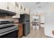 Updated kitchen features stainless steel appliances, tile floors, and an adjacent dining area with natural light at 7582 Lyncrest St, North Port, FL 34287