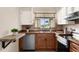 Well-equipped kitchen with stainless steel appliances, wood cabinetry, and a functional layout, ideal for cooking and meal preparation at 7582 Lyncrest St, North Port, FL 34287