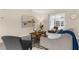 Comfortable seating area featuring a plush sofa, side chairs, and a sliding door that leads to an outdoor space at 7582 Lyncrest St, North Port, FL 34287