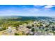 Extensive aerial shot displaying an area with established homes, dense trees, and connecting roads at 7582 Lyncrest St, North Port, FL 34287
