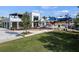 Outdoor seating area near a Oak & Stone restaurant, showcasing modern architectural design with a park and green space at 7582 Lyncrest St, North Port, FL 34287