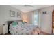 Cozy bedroom with a queen-sized bed, bright lighting, and decorative touches at 763 Lakeside Dr, North Port, FL 34287