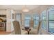 Dining area with a round glass table, upholstered chairs, and natural light from nearby windows at 763 Lakeside Dr, North Port, FL 34287