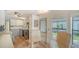 Eat-in kitchen area featuring a glass table set and view from the large window at 763 Lakeside Dr, North Port, FL 34287