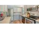 Well-lit kitchen with stainless steel appliances and ample counter space for meal preparation at 763 Lakeside Dr, North Port, FL 34287