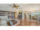 Bright and airy living room featuring a ceiling fan, hardwood floors, and an entertainment center at 763 Lakeside Dr, North Port, FL 34287