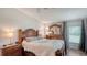 Serene bedroom featuring hardwood floors, ample natural light, and a comfortable queen size bed at 763 Lakeside Dr, North Port, FL 34287