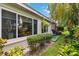 Beautiful backyard with mature trees, tropical landscaping, and a well-maintained lawn for outdoor enjoyment at 1110 Southlake Ct, Venice, FL 34285