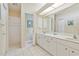 Bathroom showcasing a double vanity, bright lighting, and access to a separate toilet room at 1110 Southlake Ct, Venice, FL 34285