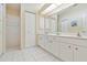 Bathroom featuring a double vanity, great lighting, and separate shower at 1110 Southlake Ct, Venice, FL 34285