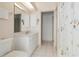 Bathroom features tiled floors, a white vanity, and access to other rooms at 1110 Southlake Ct, Venice, FL 34285